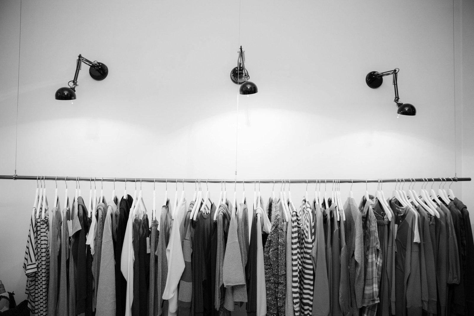 pexels-photo-1884584-1884584 Minimalist black and white clothing display in a stylish boutique setting.